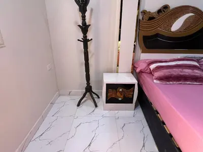a bedroom with a bed and a table with a box at Dream Apartment in Hurghada