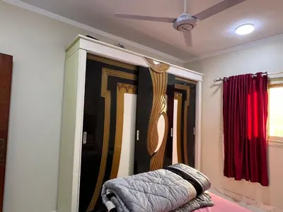a room with a closet with curtains and a bed at Dream Apartment in Hurghada