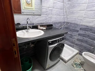 a bathroom with a sink and a washing machine at Dream Apartment in Hurghada
