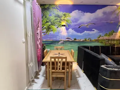 a dining room with a table and a mural of the ocean at Dream Apartment in Hurghada