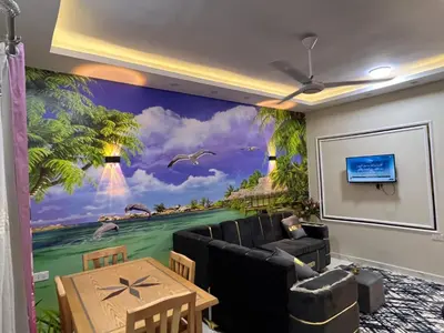 a living room with a wall mural of a beach at Dream Apartment in Hurghada