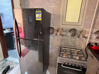 a small kitchen with a stove and a refrigerator at Dream Apartment in Hurghada