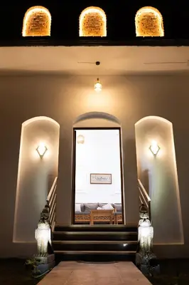 a hallway with stairs leading to a bedroom with lights at Horus Garden House in Luxor
