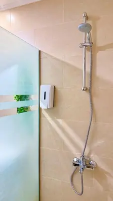 a shower with a shower head in a bathroom at Aldau Heights Hurghada Prestige Spacious Hotel-Style Poolview 1BR in Hurghada