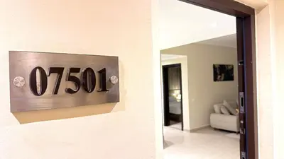 a door sign that reads on a wall at Aldau Heights Hurghada Prestige Spacious Hotel-Style Poolview 1BR in Hurghada