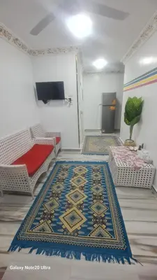 a living room with a rug on the floor at Aladino Nubian Soul in Aswan