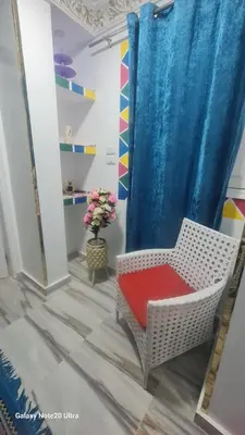 a room with a chair with a blue curtain at Aladino Nubian Soul in Aswan