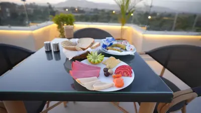 a table with two plates of food on it at The View Luxor hotel in Luxor