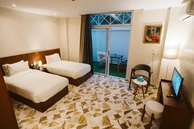 a hotel room with two beds and a balcony at The View Luxor hotel in Luxor
