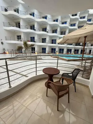 a balcony of a hotel with a table and chairs at Diamond resort Hurghada 7 in Hurghada