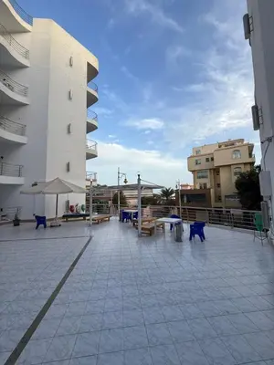 a patio with tables and chairs on a building at Diamond resort Hurghada 7 in Hurghada