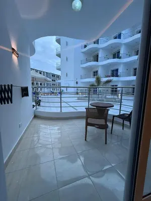 a balcony with a table and chairs and a building at Diamond resort Hurghada 7 in Hurghada