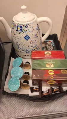 a tray with cookies and a teapot and a tea pot at Woori Duri \ud658\ub300\ub97c \uc704\ud574 in Aswan