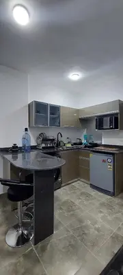 a large kitchen with a large island in the middle at Relax near the sea, one bedroom flat in Hurghada