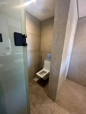 a bathroom with a toilet and a glass door at Barefoot Beachfront Cabana with Open SeaView,Mesca in Hurghada