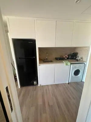 a kitchen with a black refrigerator and a dishwasher at Barefoot Beachfront Cabana with Open SeaView,Mesca in Hurghada