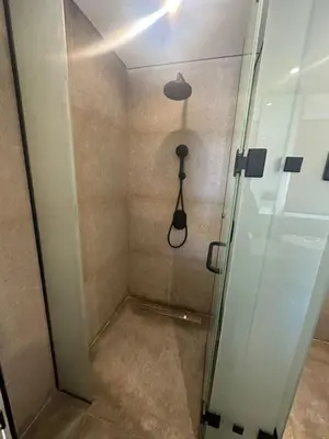 a shower in a room with a glass door at Barefoot Beachfront Cabana with Open SeaView,Mesca in Hurghada