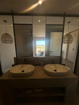 a bathroom with two sinks and a large mirror at Barefoot Beachfront Cabana with Open SeaView,Mesca in Hurghada