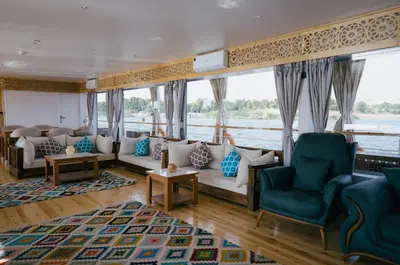 a living room with couches and chairs on a boat at Soul of the nile Dahabyia in Al Baghdādī