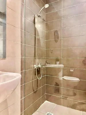a bathroom with a shower with a toilet and a sink at G Grips Grand 4 in El Gouna