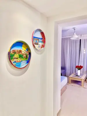 three plates hanging on a wall in a room at G Grips Grand 4 in El Gouna