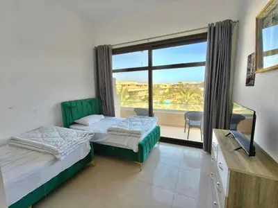 a room with two beds and a window with a view at Gcrips in El Gouna