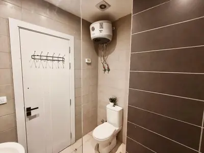 a small bathroom with a toilet and a shower at Gcrips in El Gouna