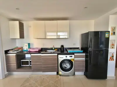 a kitchen with a refrigerator and a washing machine at Gcrips in El Gouna