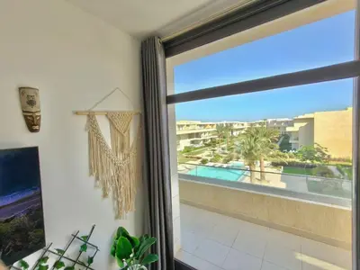 a room with a window with a view of a pool at Gcrips in El Gouna