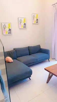 a blue couch in a living room with a table at Hayloft 1 bedroom tawila, Plaza ElGouna in Hurghada