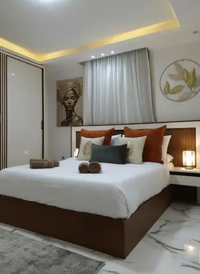 a bedroom with a large bed with a large white bedspread at HUB resort Luxury apartment on the pool in Hurghada