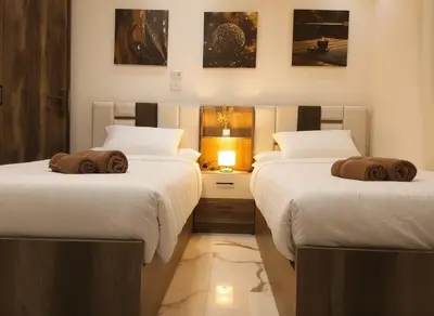 two beds with towels on them in a room at HUB resort Luxury apartment on the pool in Hurghada