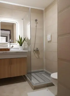 a bathroom with a shower and a toilet and a sink at HUB resort Luxury apartment on the pool in Hurghada