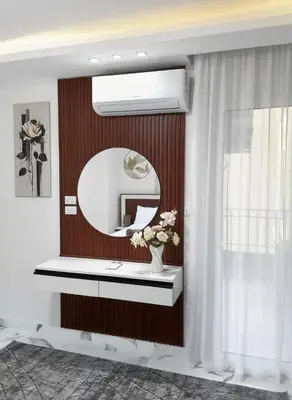a bathroom with a mirror and a vase with flowers at HUB resort Luxury apartment on the pool in Hurghada