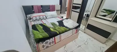 a small bed in a room with a mirror at La Bellal Star Hurghada A103 in Hurghada