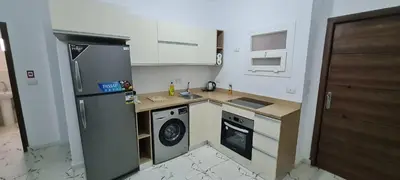 a small kitchen with a refrigerator and a dishwasher at La Bellal Star Hurghada A103 in Hurghada