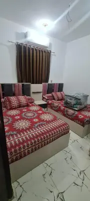 a bedroom with two beds and a curtain at La Bellal Star Hurghada A103 in Hurghada