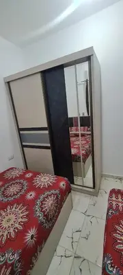 a room with a mirror and a bed and a chair at La Bellal Star Hurghada A103 in Hurghada