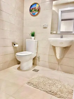 a bathroom with a toilet and a sink at El Gouna in Hurghada