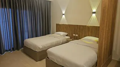 a hotel room with two beds and a window at Paradise Studio with pool in Hurghada