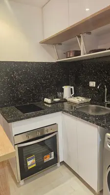 a kitchen with a stove and a sink at Paradise Studio with pool in Hurghada