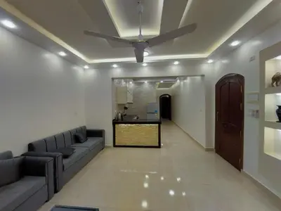 a living room with a couch and a ceiling fan at الاقصر in Luxor