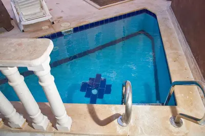 a swimming pool with a table and a pool at Juliana beach luxury family suites in Hurghada