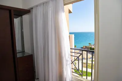 a room with a window with a view of the ocean at Juliana beach luxury family suites in Hurghada