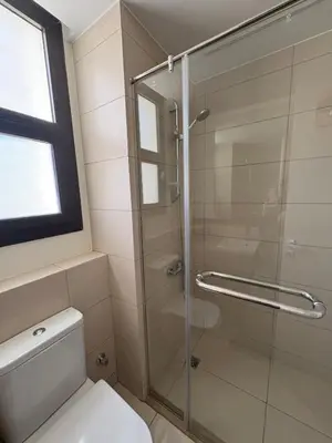 a bathroom with a shower and a toilet at Boho El Gouna Shedwan 2BD Beach & Pool Access in Hurghada