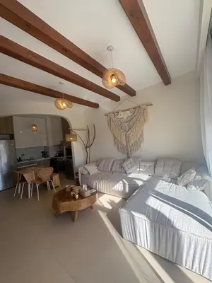 a living room with two beds and a table at Boho El Gouna Shedwan 2BD Beach & Pool Access in Hurghada