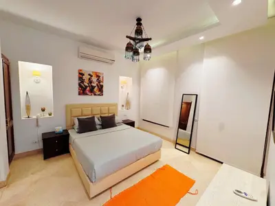 a bedroom with a bed and a chandelier at El Gouna - Sabina - Lagoon Chalet - 2 bedrooms - Ground Floor in El Gouna