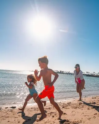 a group of people running on the beach at Scandic resort near diving center Colona Divers Hotel Room in Hurghada