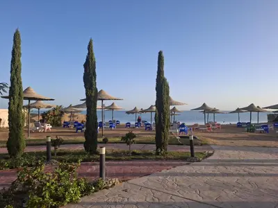 a beach with umbrellas and chairs and the ocean at Casblanka beach in Hurghada