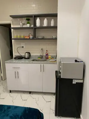 a small kitchen with a sink and a refrigerator at Sea Light Arabia in Hurghada